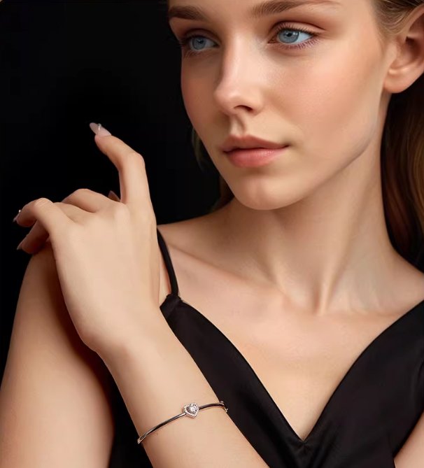 A woman's wrist wearing a heart moissanite bangle