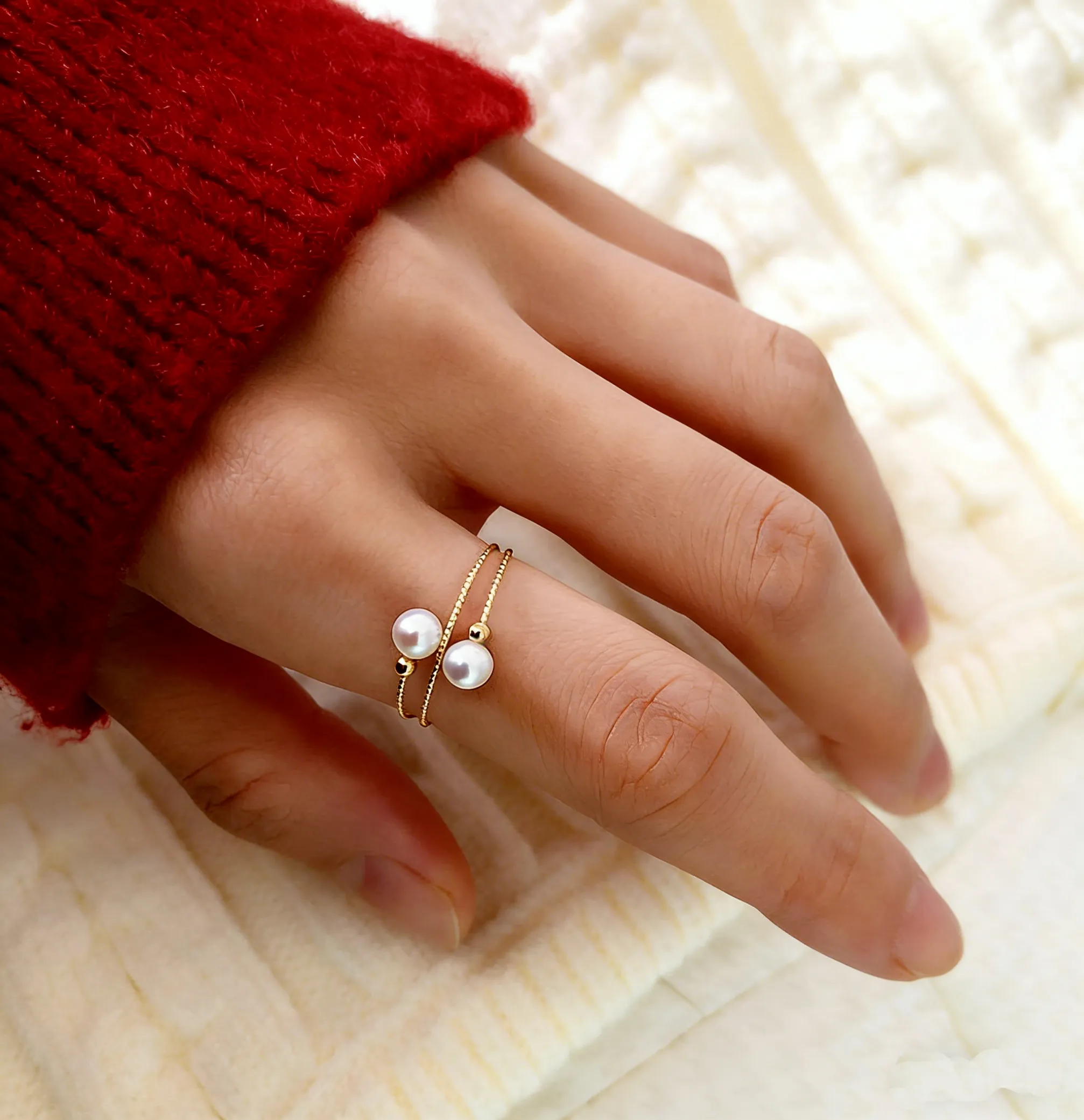 Model wearing 18K gold akoya seawater small pearl ring, showing adjustable fit