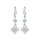 Four-leaf clover sterling silver drop earrings with white cubic zirconia stone on white background