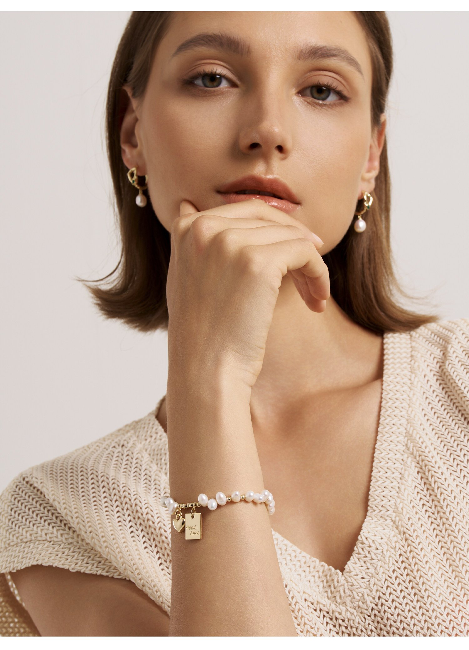 Freshwater pearl gold charm bracelet on wrist – adjustable extender chain