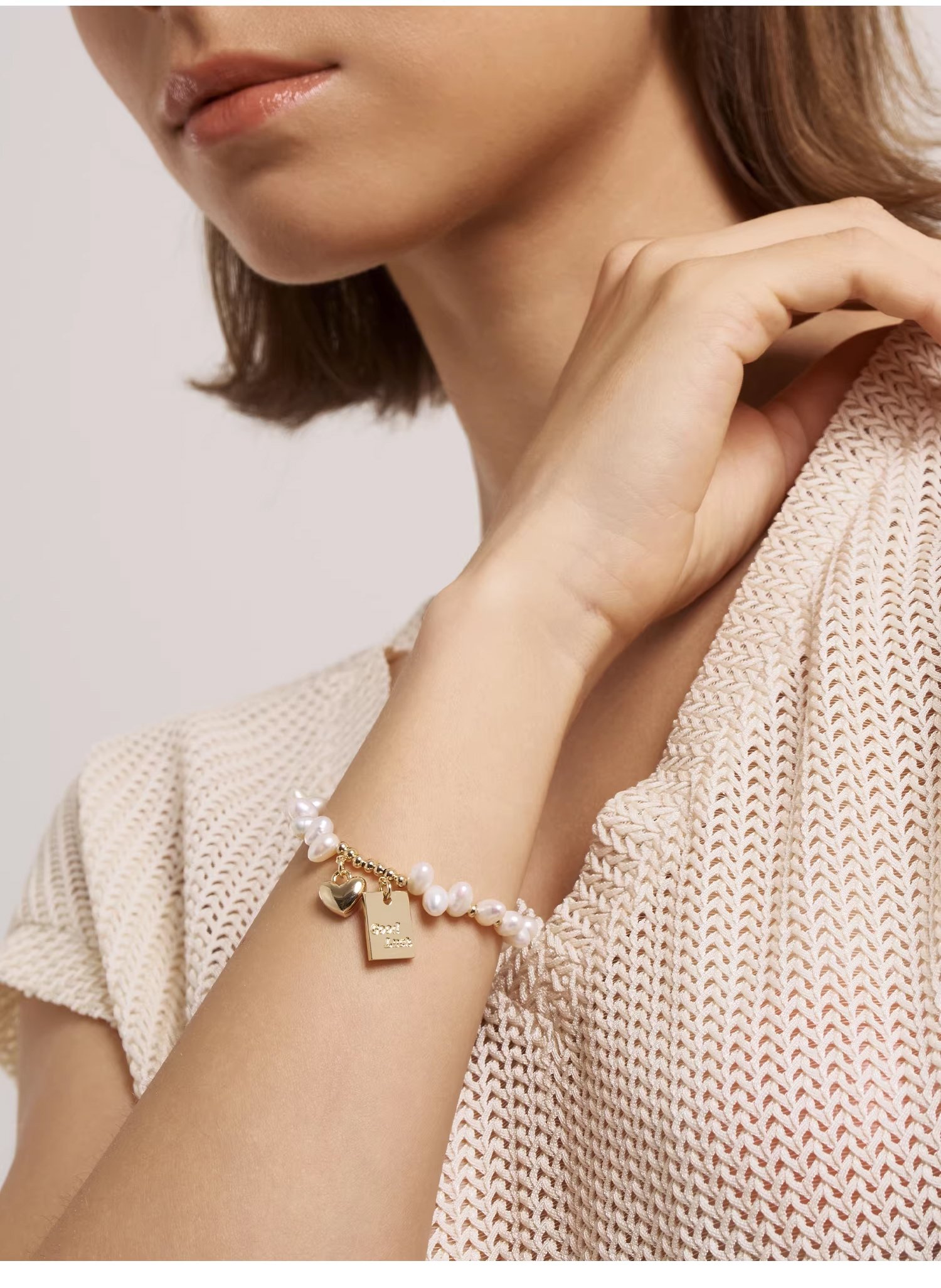 Freshwater pearl gold charm bracelet on wrist – adjustable extender chain