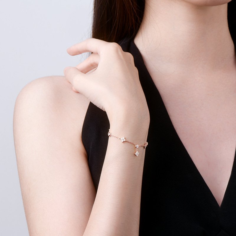 SYMARA lucky clover bracelet worn on wrist stacked with other bracelets