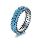 Front view of SYMARA S925 sterling silver turquoise ring, showcasing full pavé-set synthetic turquoise stones and classic eternity band design.