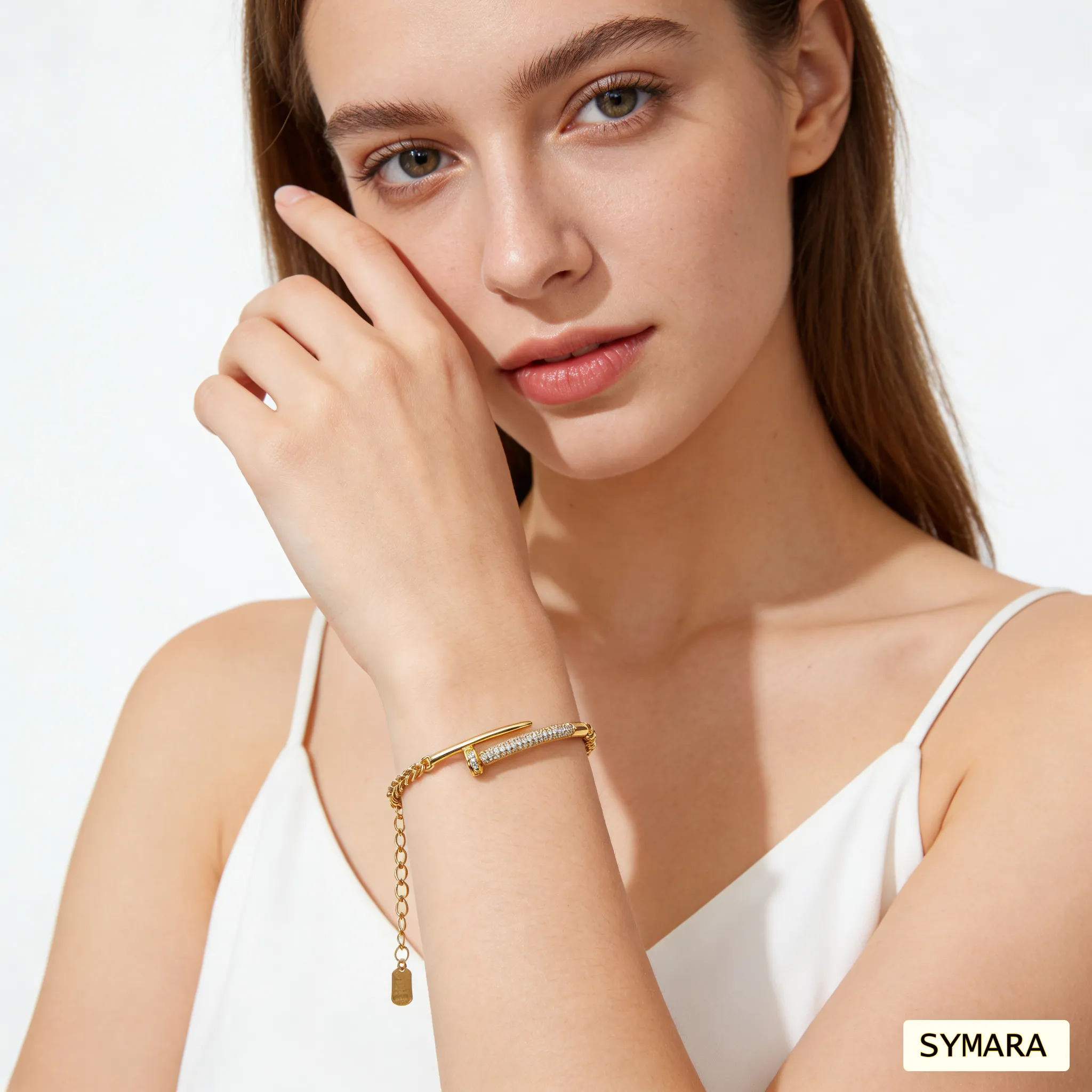 adjustable-studded-bracelet-on-wrist-fit-extension-chain Model showcasing a gold studded bracelet with tiny polished studs, 18k gold plating over sterling silver base, thin chain design perfect for layering with watches or bangles.