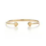 SYMARA Classic Heart Open Bangle in S925 sterling silver with 18K gold plated finish on white background