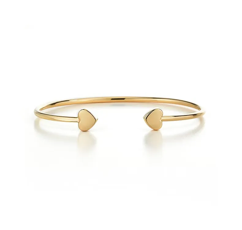 SYMARA Classic Heart Open Bangle in S925 sterling silver with 18K gold plated finish on white background