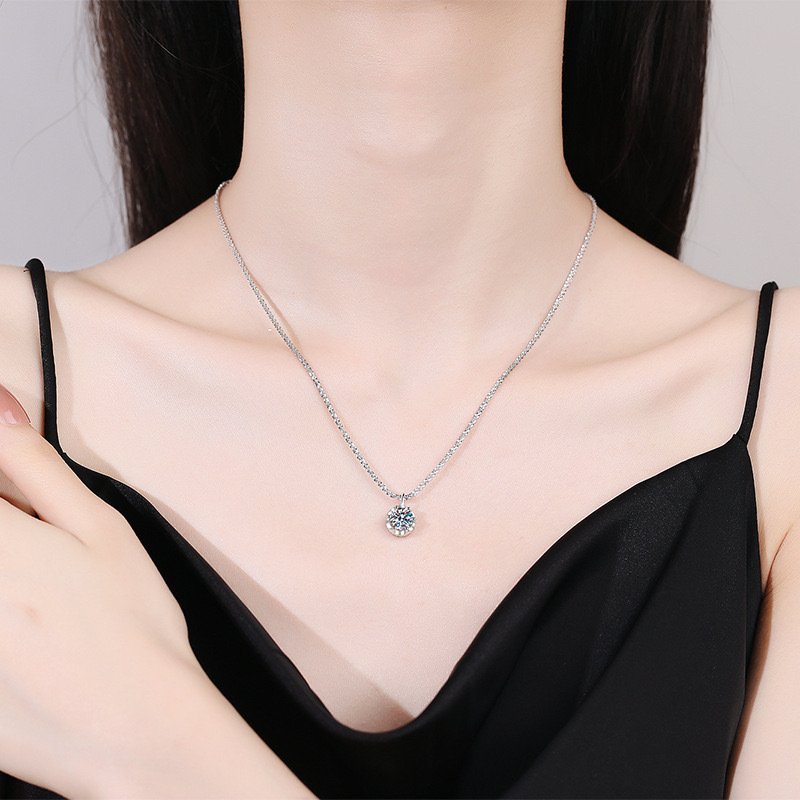 Woman wearing D-color moissanite necklace resting at collarbone