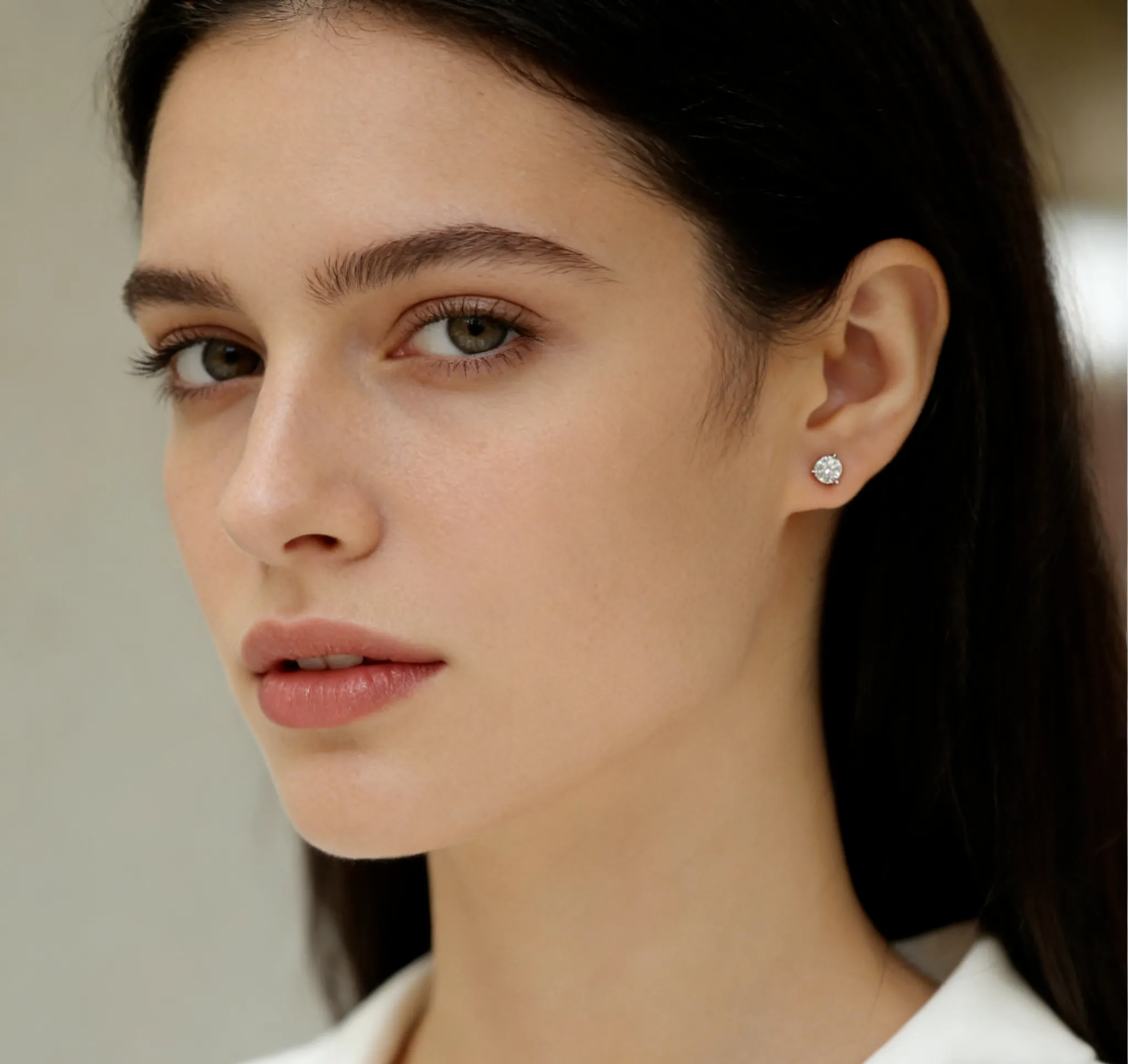 Woman wearing 1ct lab grown diamond stud earrings in 18K white gold, side view