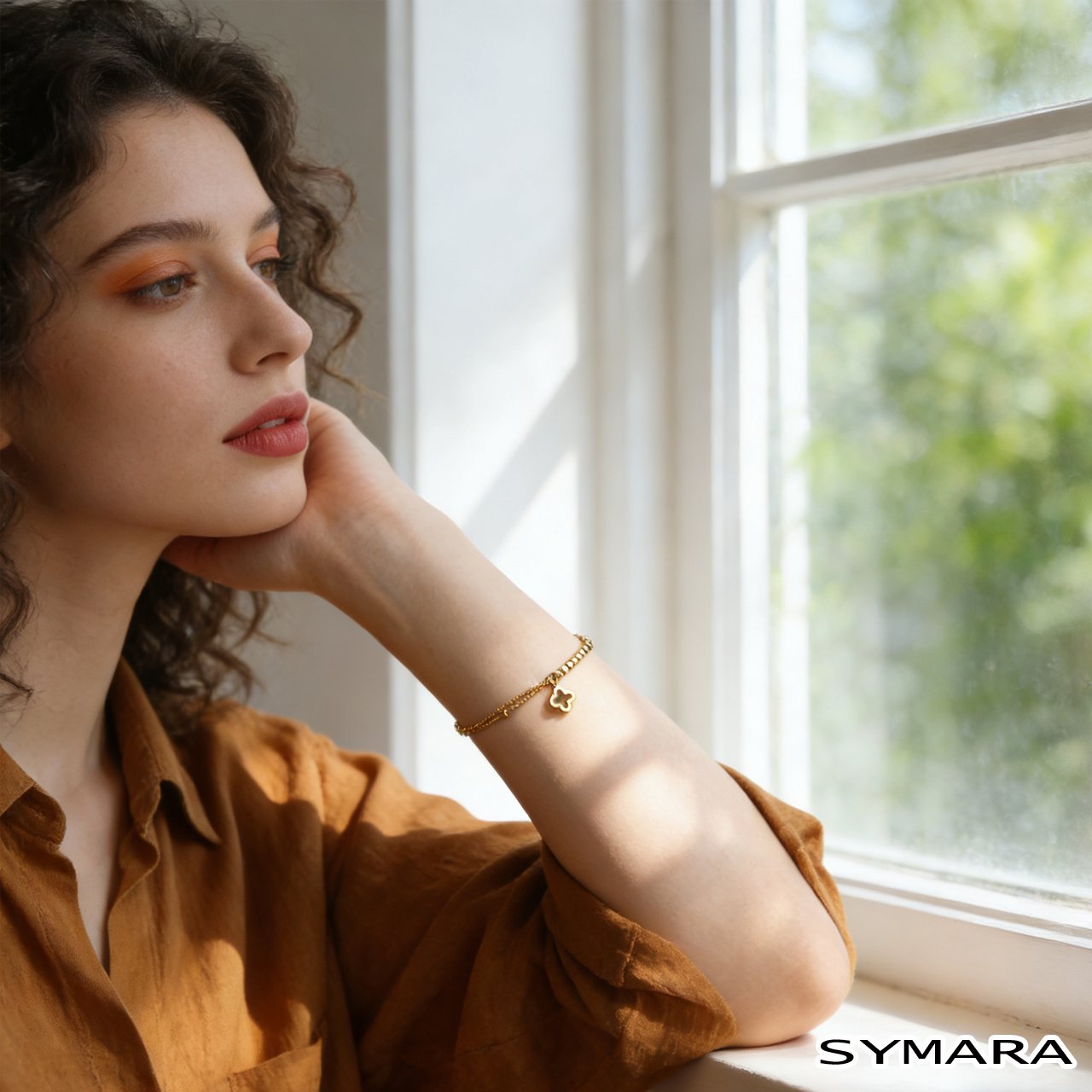 Gold clover bracelet resting on a modern office desk next to a laptop and coffee cup, capturing the delicate shine of the S925 silver gold-plated clover bracelet, a versatile accessory for professional and casual settings.