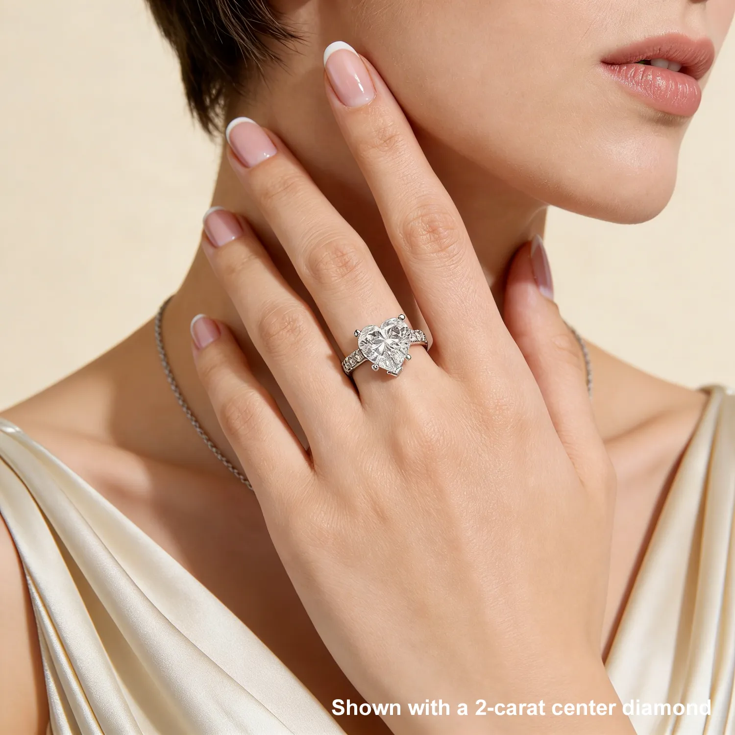 Model wearing 18K white gold half coverage heart diamond ring on hand