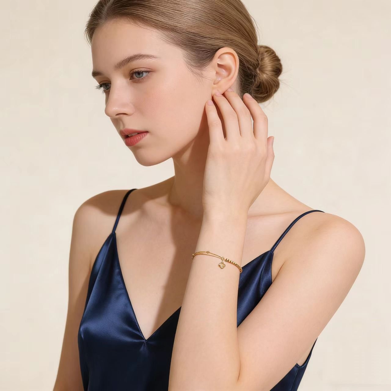 model-wearing-gold-clover-bracelet-wrist-image