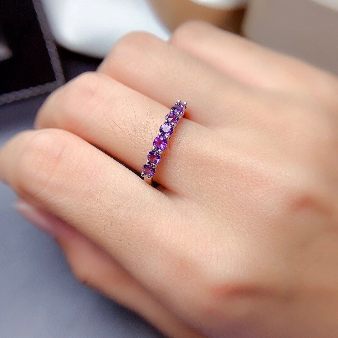 adjustable amethyst ring worn on wrist, natural purple gemstones, half eternity design