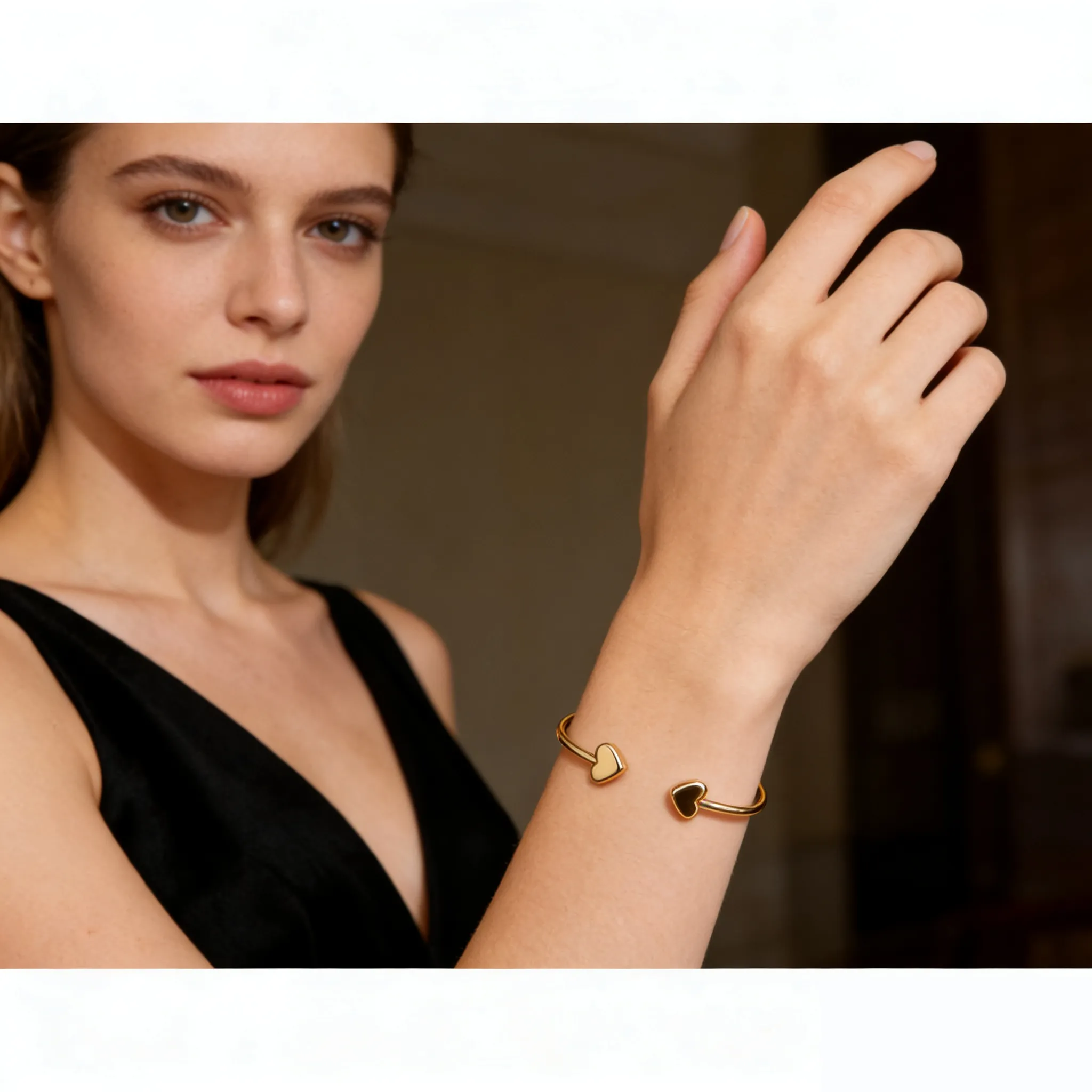 Woman wearing SYMARA adjustable heart open cuff bracelet in 18K gold, layered with other bracelets