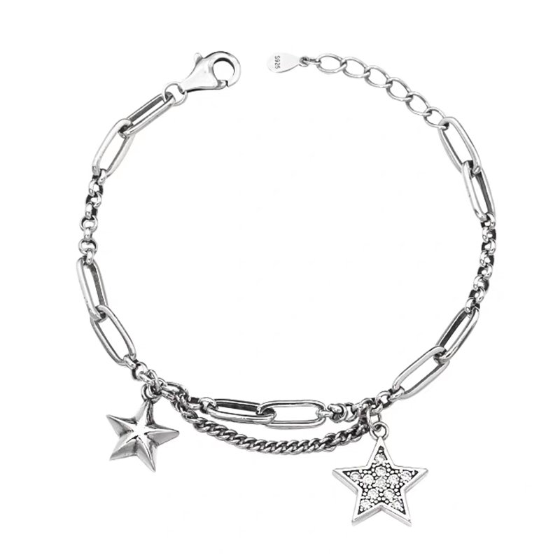 Vintage star 925 sterling silver layered bracelet on neutral background, featuring oxidized finish double chain design with star charms and cubic zirconia accent, handcrafted Thai silver jewelry from SYMARA.