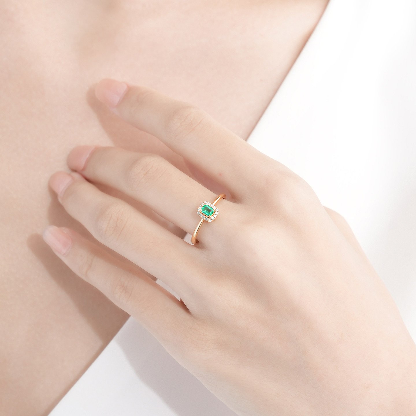 Woman Wearing Luxury Emerald Diamond Ring