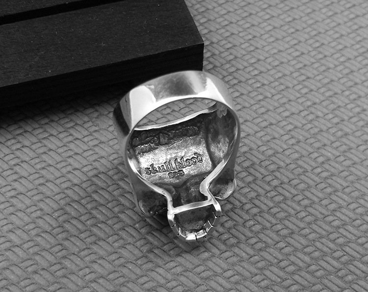 Closeup of red corundum heart inlay, vintage skull subtle heart ring mens craft