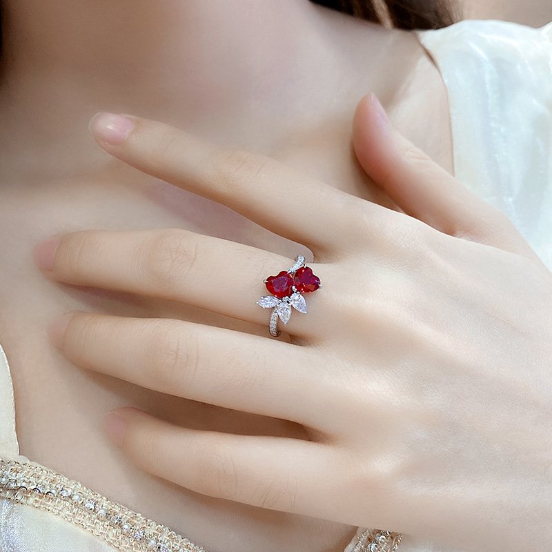 Minimalist jewelry double heart ruby ring worn on finger, elegant women’s anniversary style