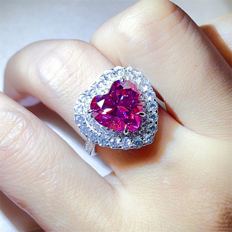 pink-heart-moissanite-ring-hand-model-wearing Woman’s hand wearing 5CT pink heart moissanite ring, statement style