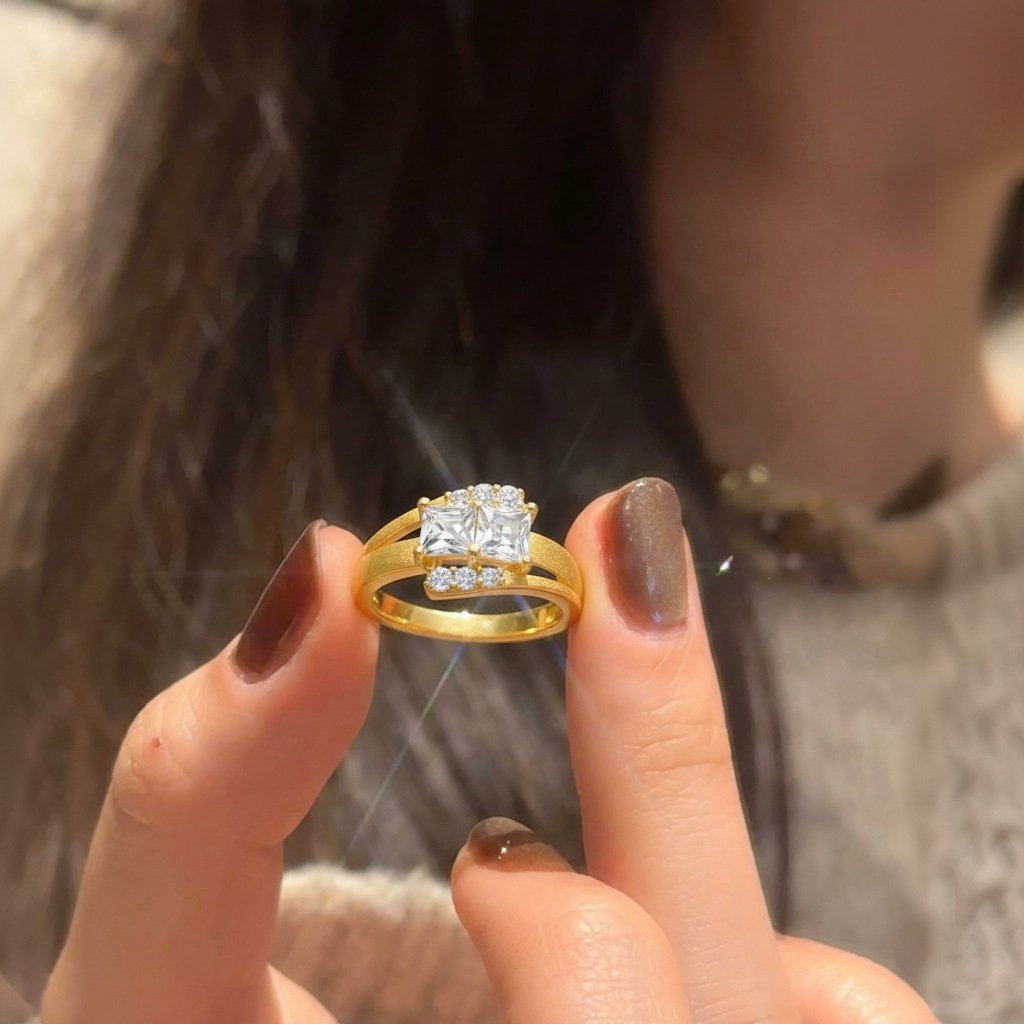 Close-up of woman’s hand wearing princess cut moissanite ring, gold tone