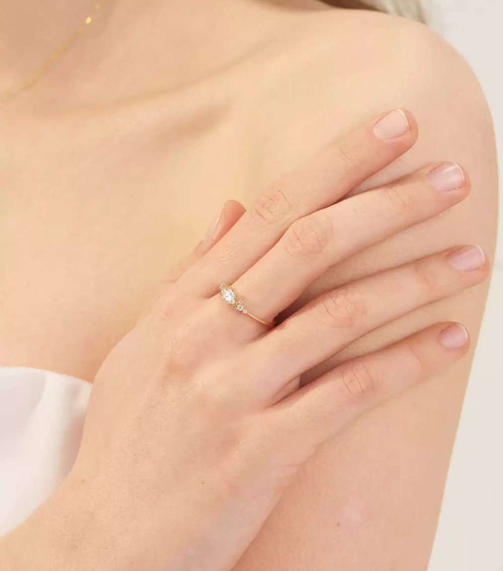 Close-up detail of promise ring made of 14k gold with sparkling lab grown diamonds