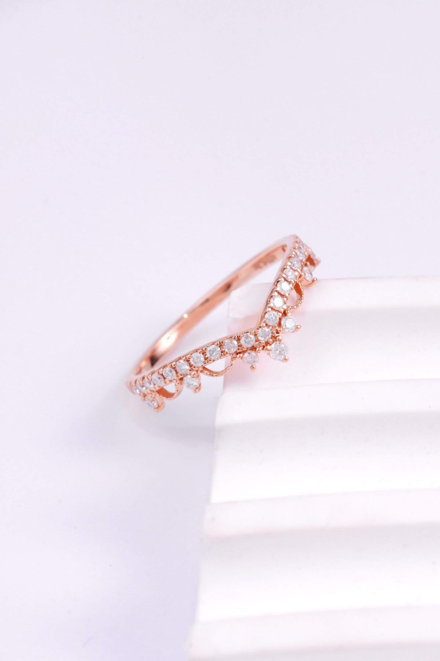 Side view of rose gold women commitment ring with delicate crown setting