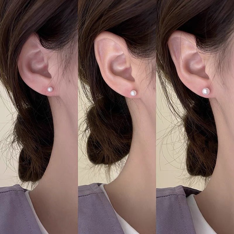 4mm-pearl-stud-earrings-on-ear-model-symara Model wearing 4mm small freshwater pearl stud earrings daily