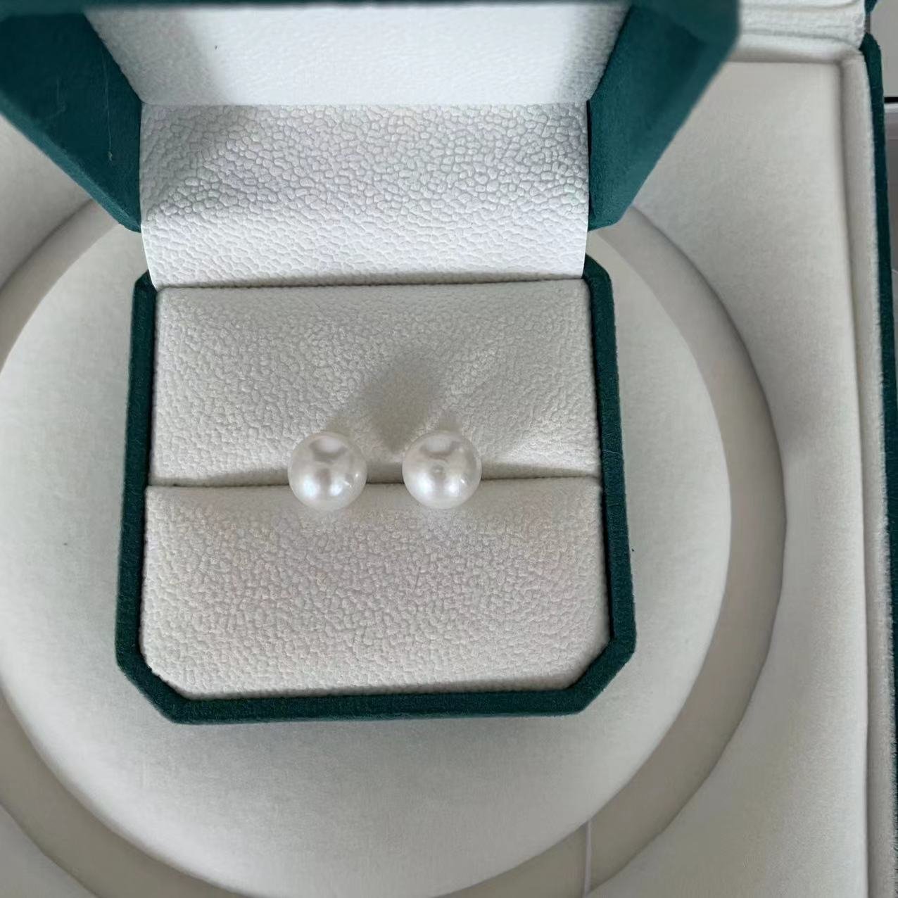 8mm white round freshwater pearl stud earrings displayed in green velvet jewelry box