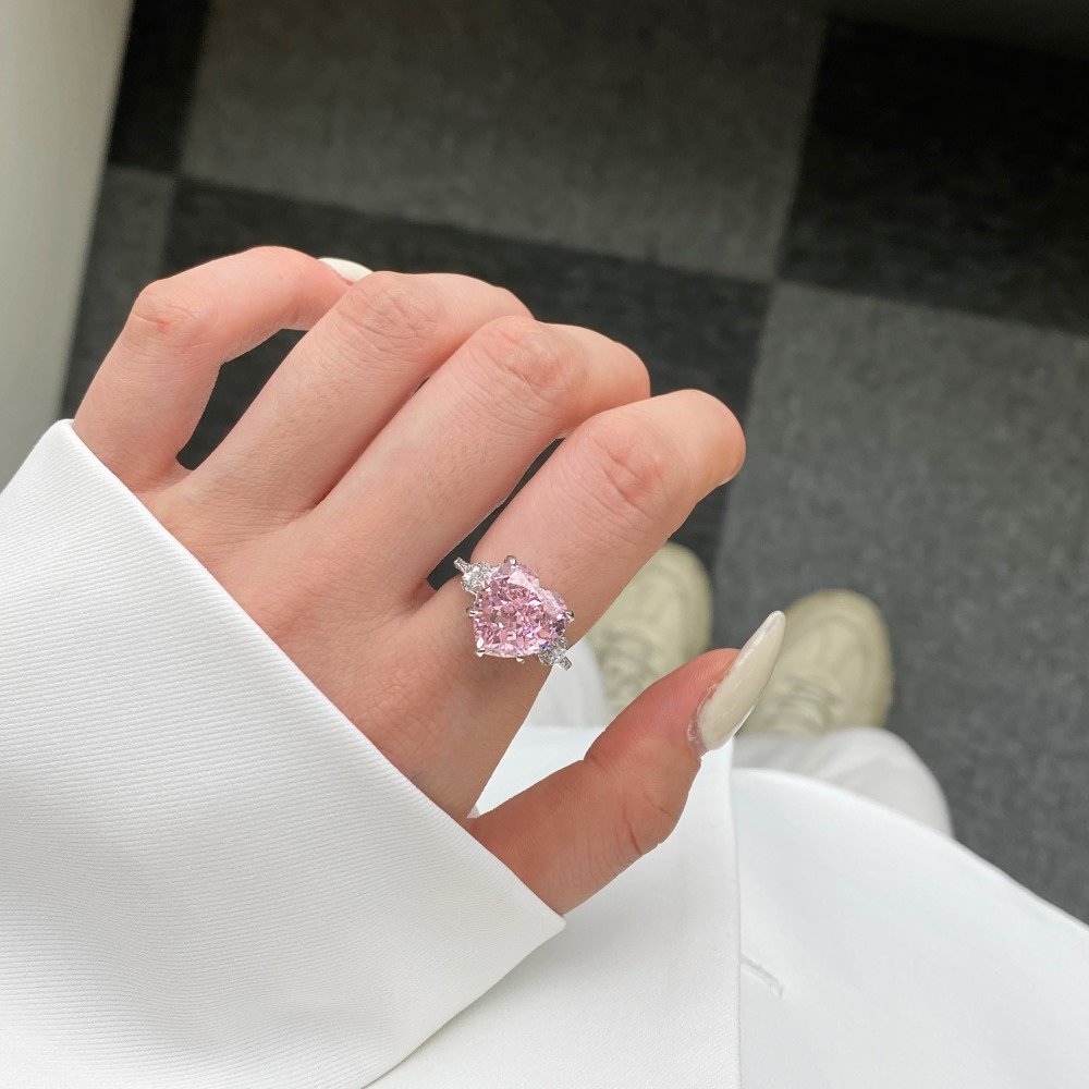 Model wearing sterling silver pink heart ring on finger