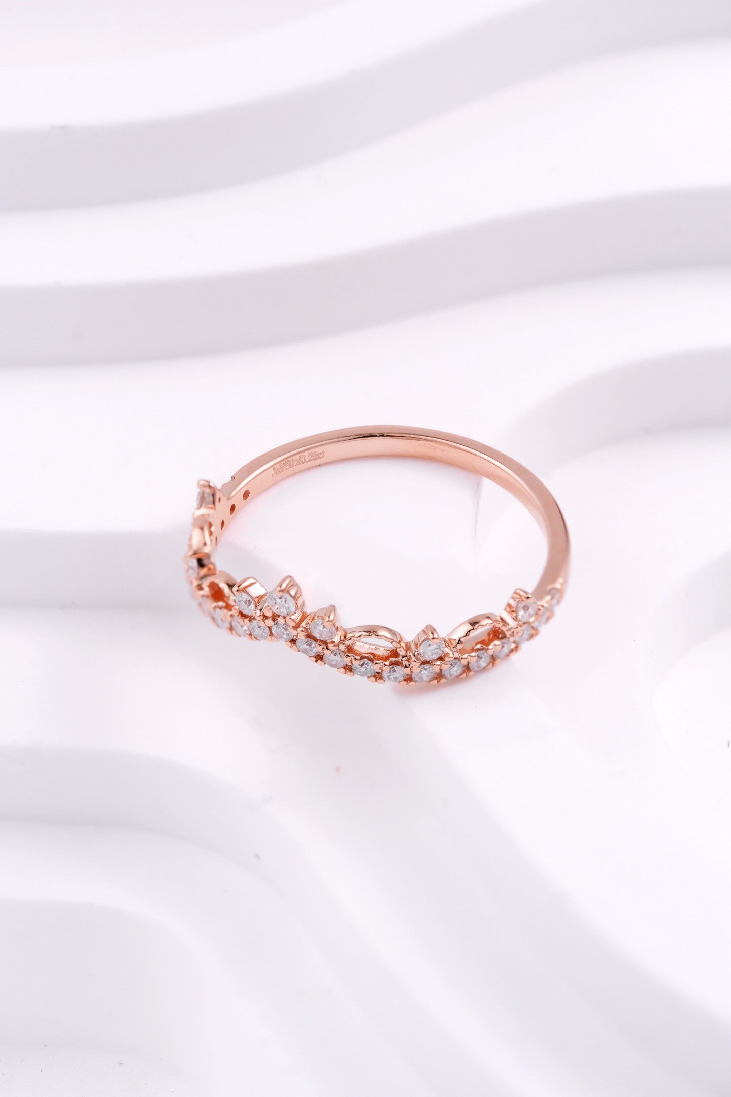 Side view of rose gold women commitment ring with delicate crown setting