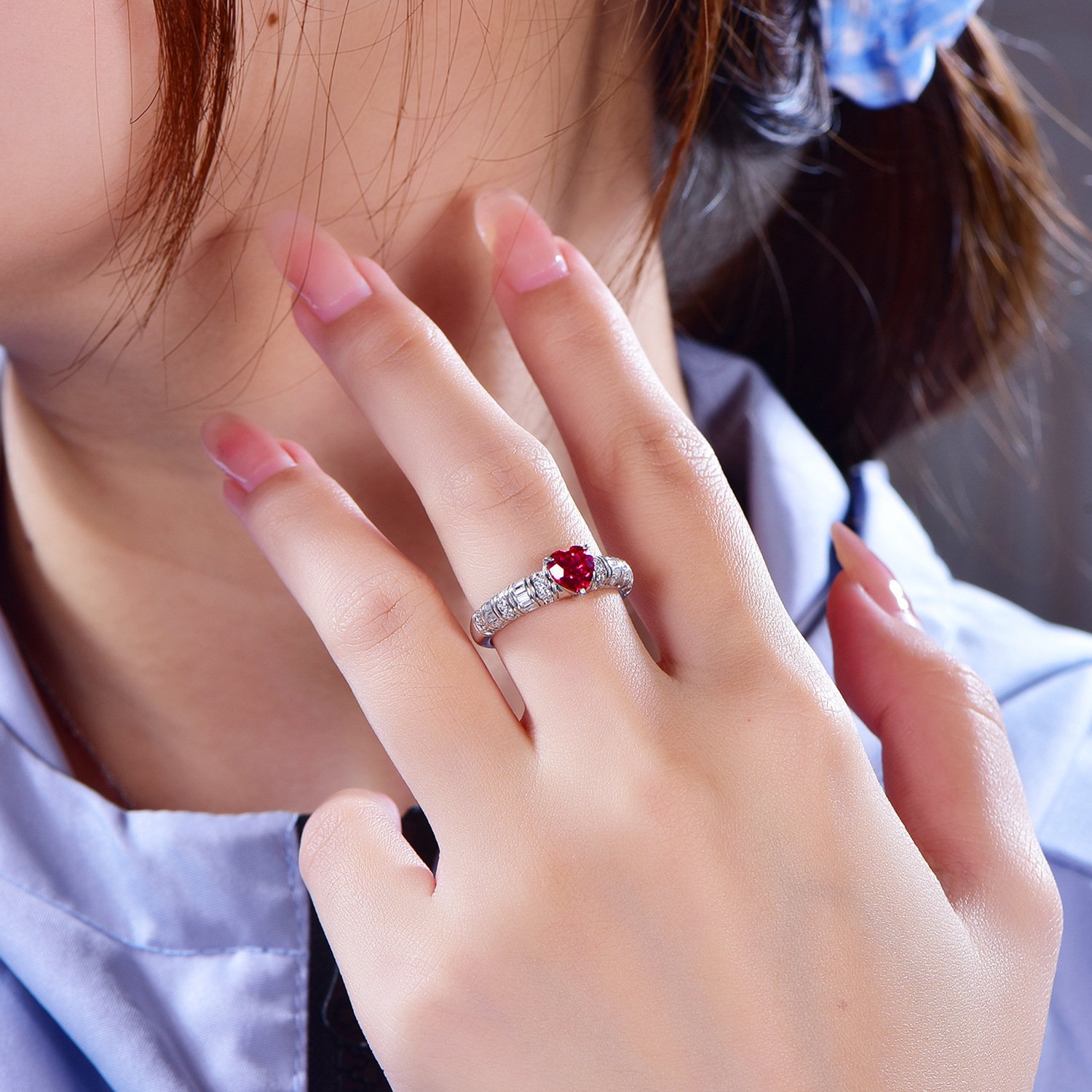 ruby-ring-for-women-on-hand-gift Woman wearing a heart-shaped ruby ring, ideal as a gift for her wife.