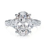 Three stone oval moissanite ring in sterling silver with 4.5ct main stone and tapered baguette accents.