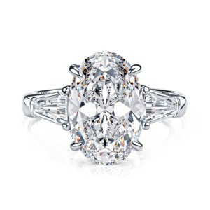 Three stone oval moissanite ring in sterling silver with 4.5ct main stone and tapered baguette accents.