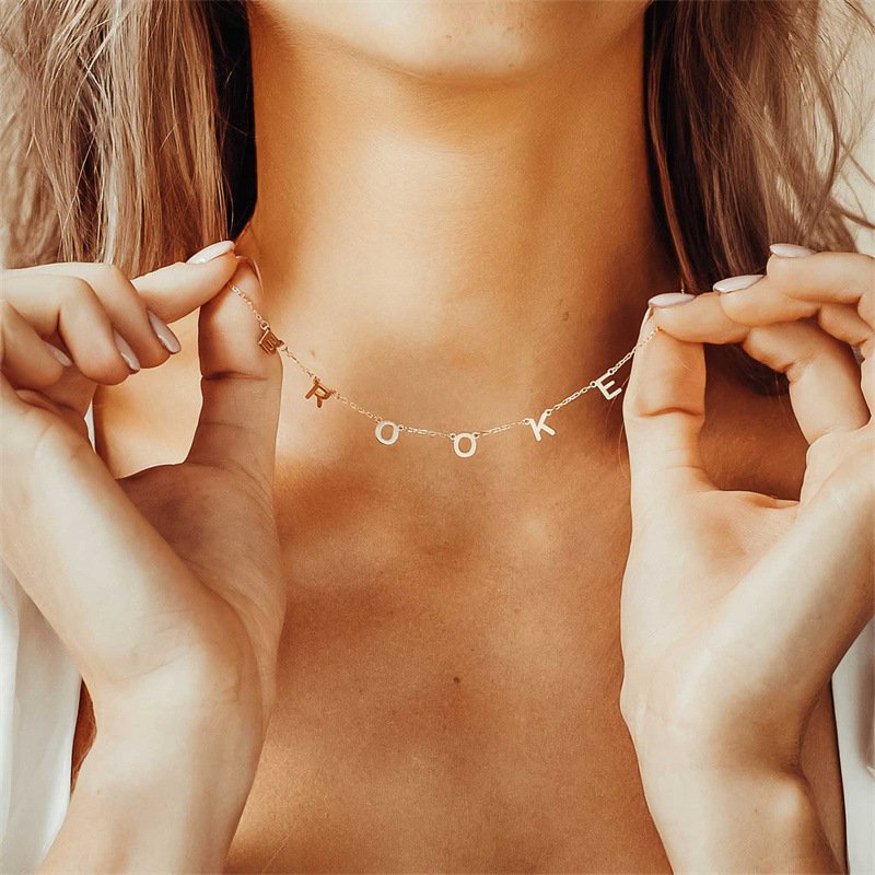 dainty-initial-letter-necklace-wearing_image Woman wearing minimalist S925 silver initial letter clavicle necklace
