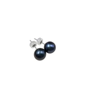 Side view of round grey-black pearl post earrings with white gold tone silver pins laid on cream velvet padding