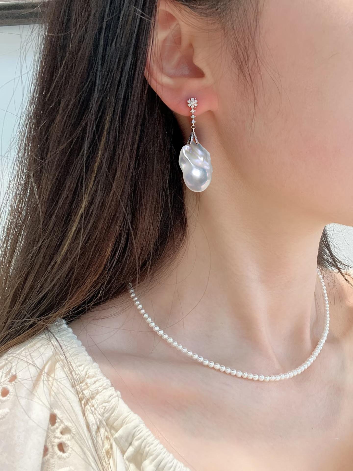 Model wearing 5cm white baroque pearl earrings, hypoallergenic S925 silver needle luxury earrings
