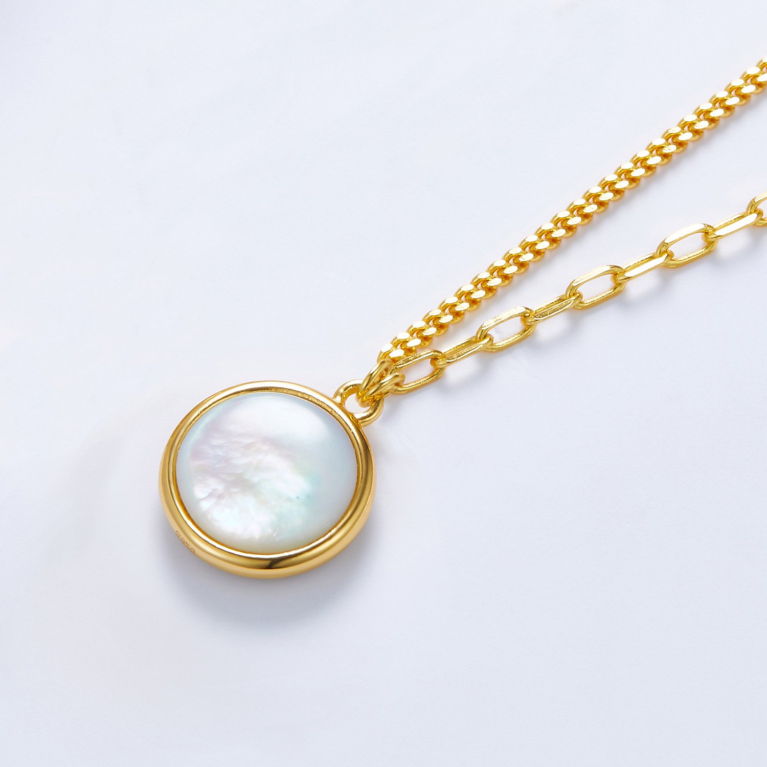 Close-up of natural mother of pearl surface on 1.2cm round disc necklace