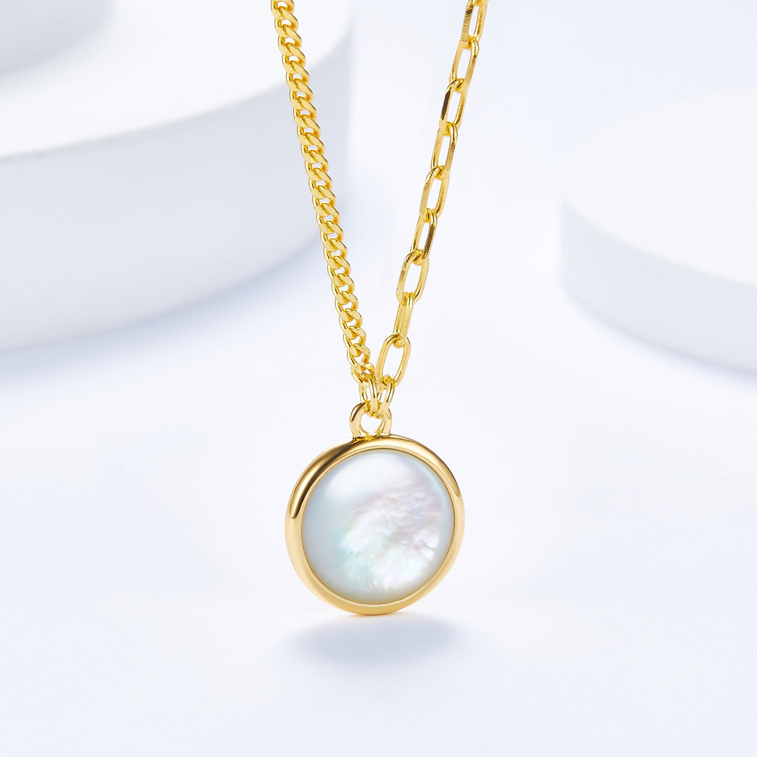 Close-up of natural mother of pearl surface on 1.2cm round disc necklace