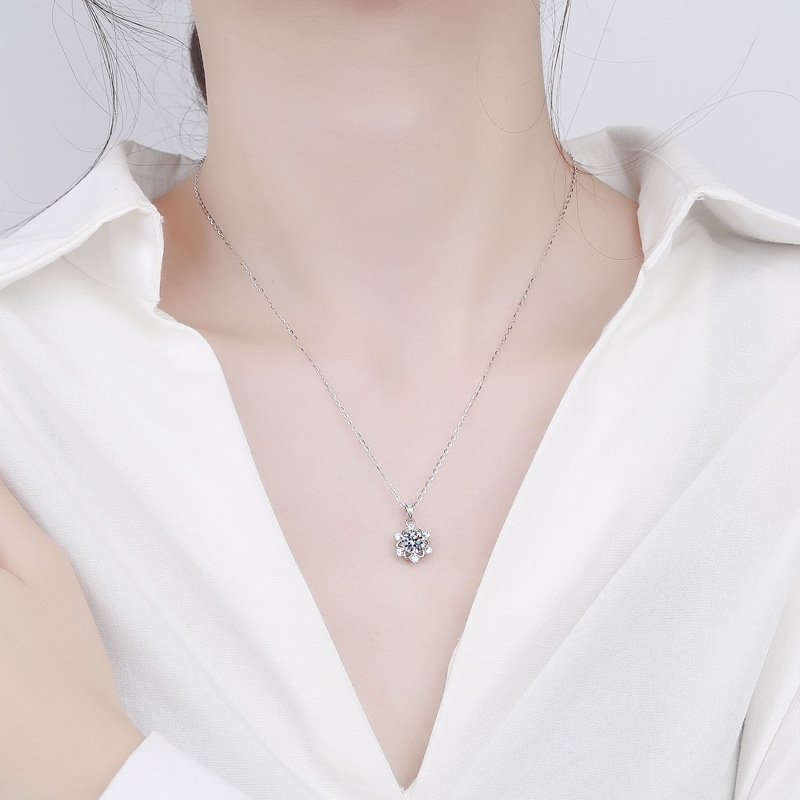 Woman wearing snowflake moissanite necklace, delicate collarbone chain for everyday wear