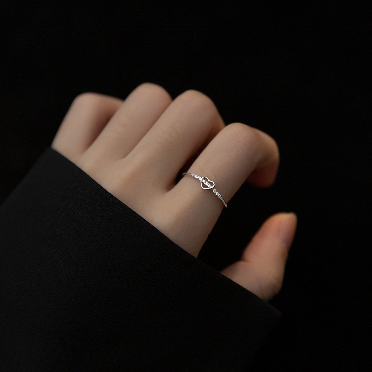 tiny silver heart ring worn on finger for casual look