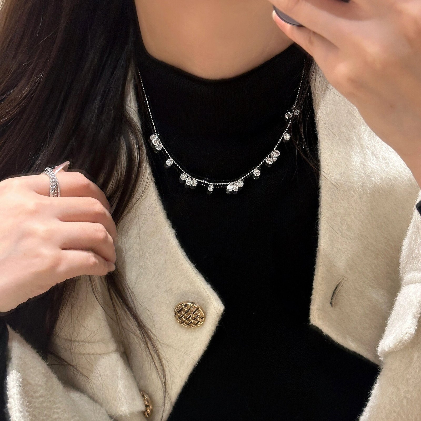 woman-wearing-shimmering-cz-drop-necklace Woman wearing starburst cubic zirconia necklace for everyday chic look
