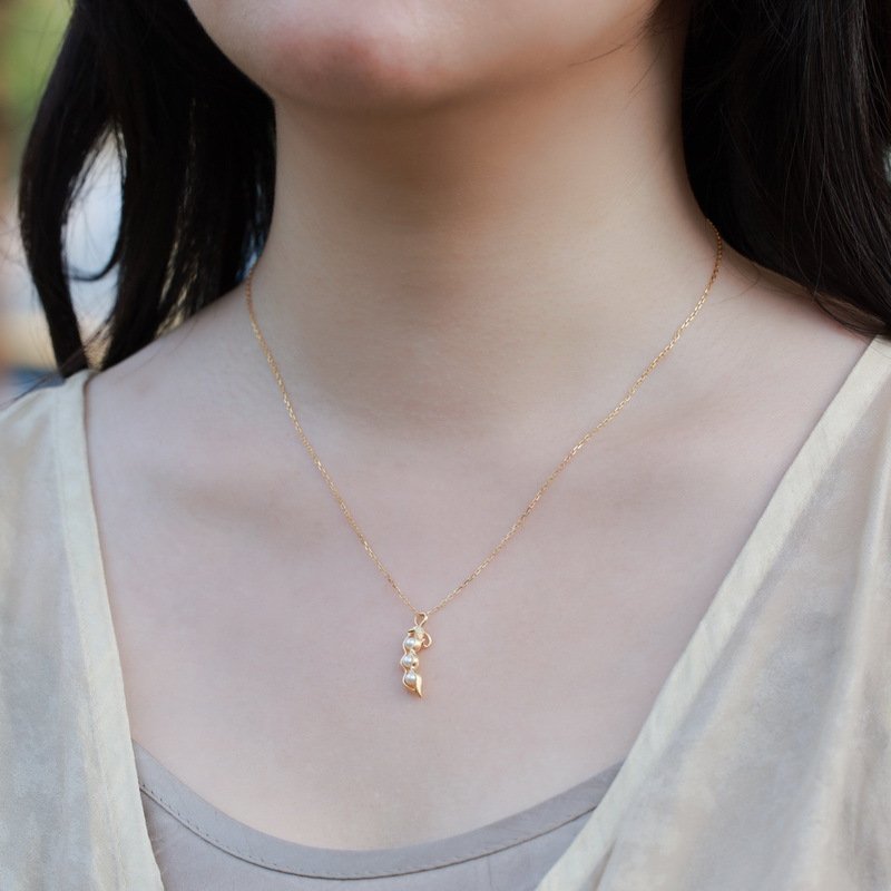 Pea pod pearl necklace worn on neck, elegant vintage style for everyday outfits