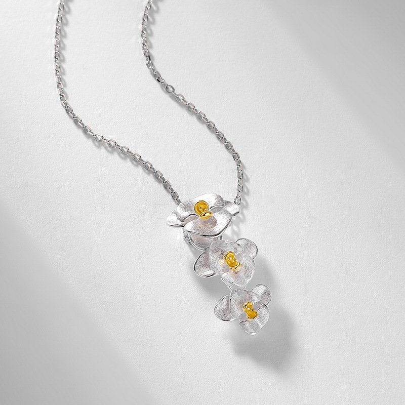 Delicate cascading orchid flower necklace with two-tone finish, hypoallergenic silver everyday jewelry