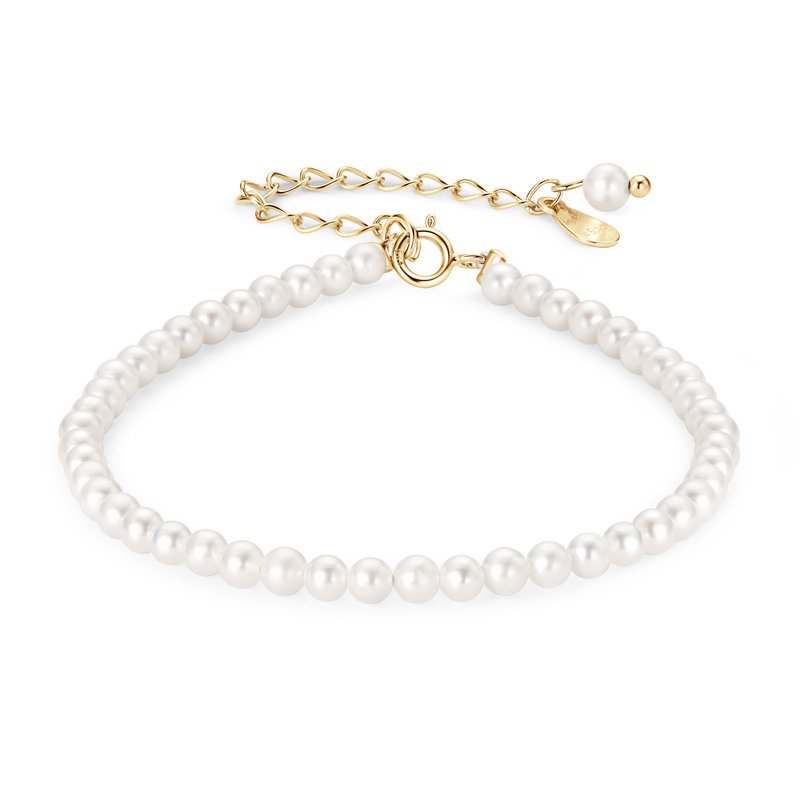 Dainty 3‑4mm white freshwater pearl bracelet 6.3 inch, gold spring ring clasp on plain white background