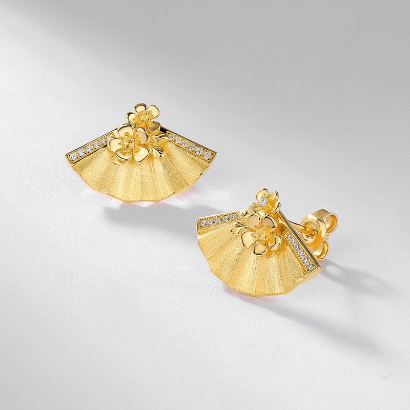 Close‑up view of hand‑brushed texture on fan‑flower moissanite stud earrings