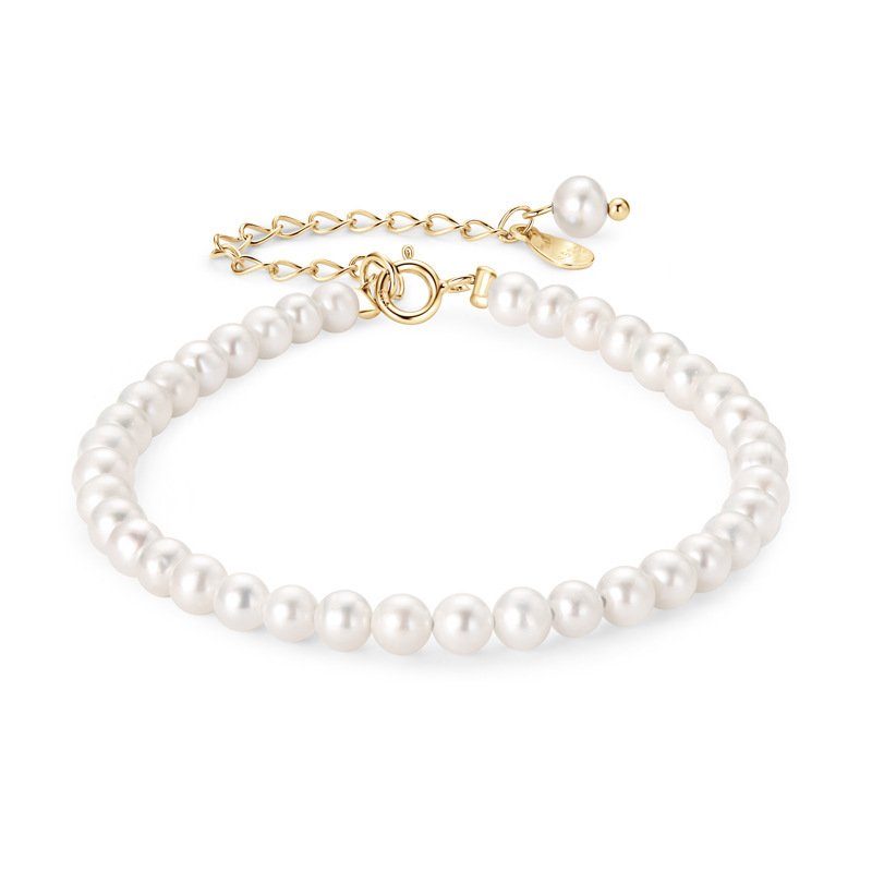 Close‑up view of petite 3‑4mm round white freshwater pearl showing soft creamy luster