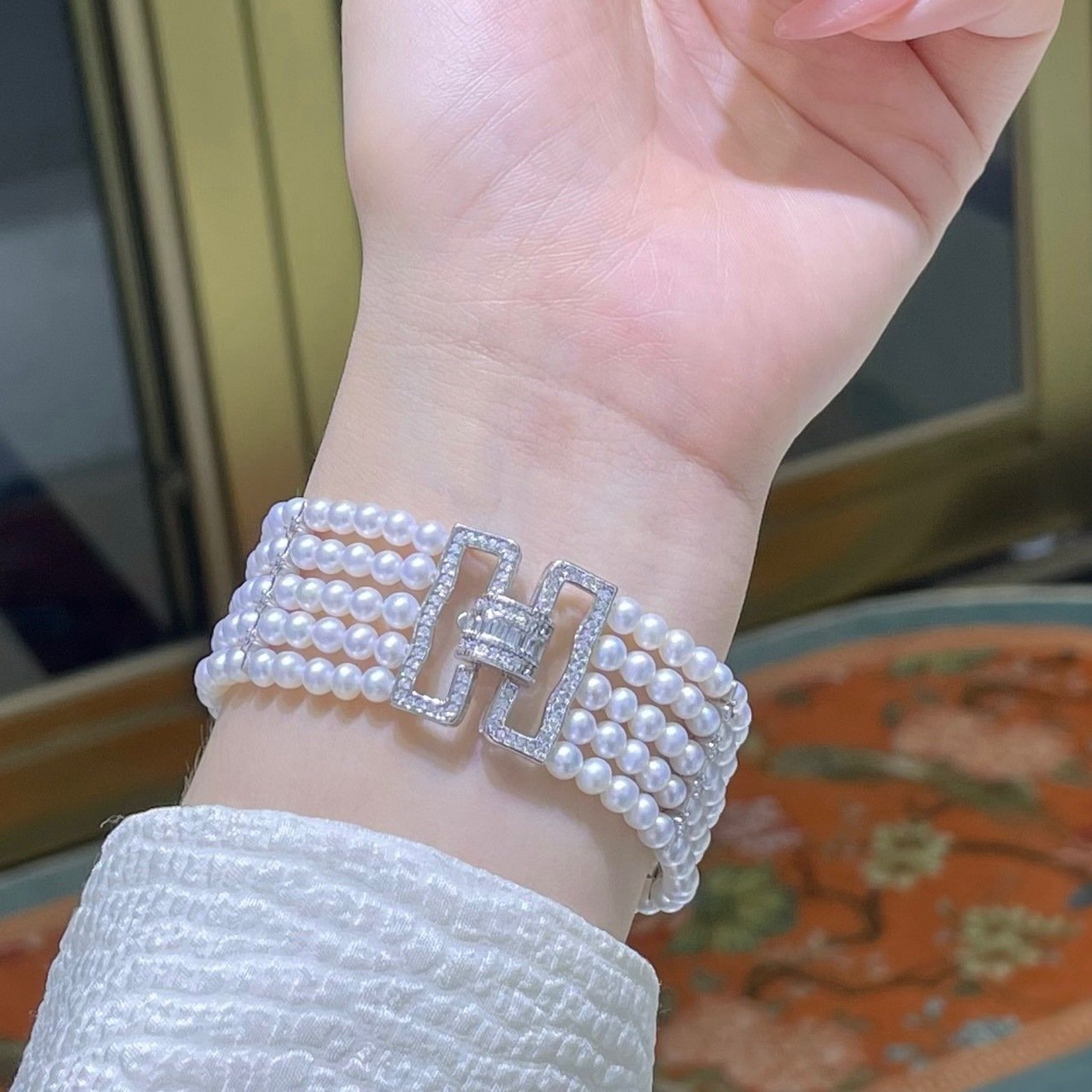 Worn shot of luxury 5‑row wide baya pearl bracelet for banquet, business and party occasion styling
