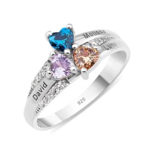 Macro shot of custom name engraving on band of 3 heart mother birthstone ring