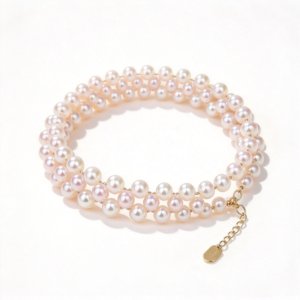 Hand-woven 3-4mm freshwater pearl bracelet laid flat, showing delicate pearl weaving texture and S925 sterling silver hardware, elegant handmade pearl jewelry detail.