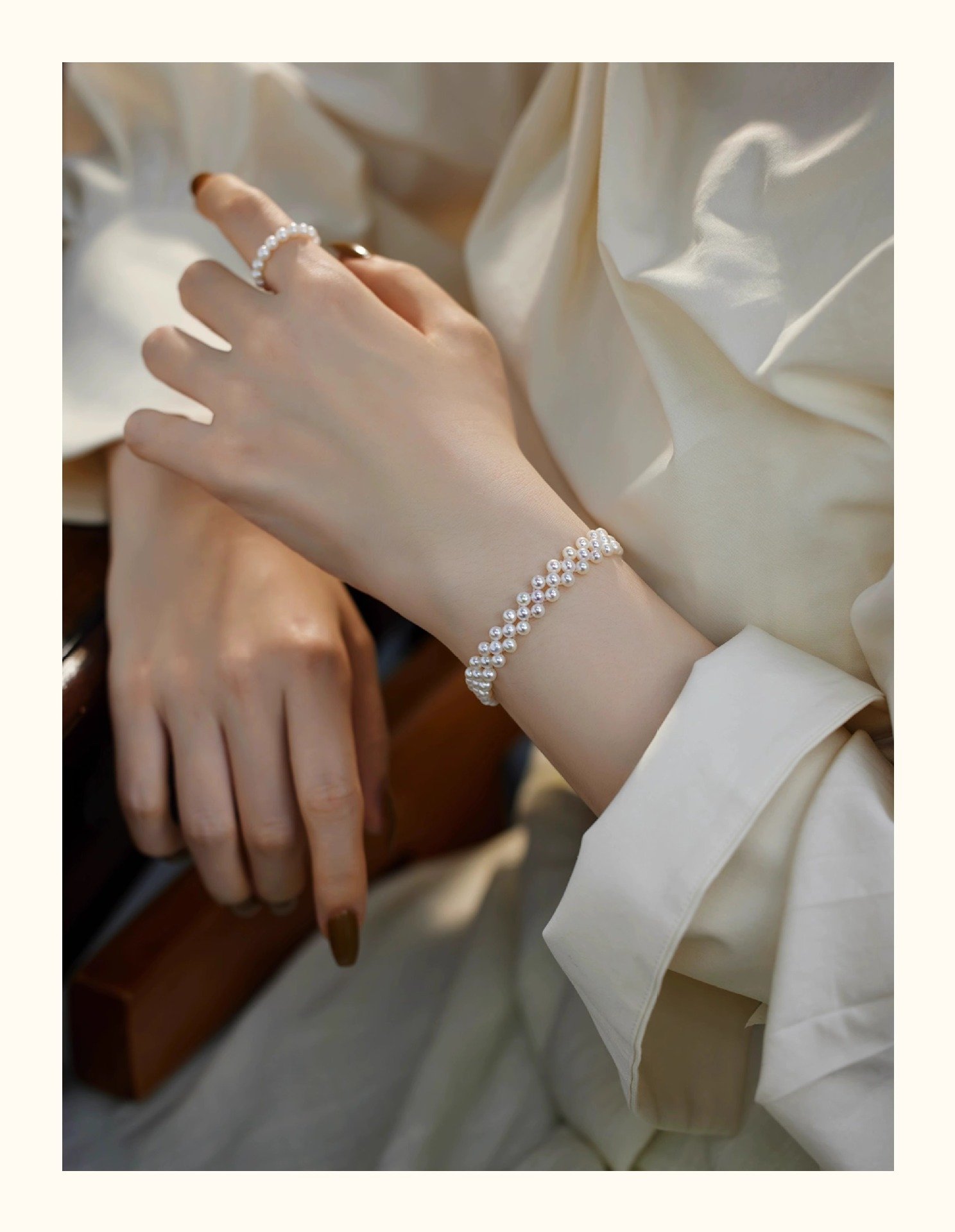 Elegant woman wearing gold-tone hand-woven freshwater pearl bracelet on wrist, 3-4mm round pearls with S925 sterling silver, sophisticated everyday pearl jewelry.