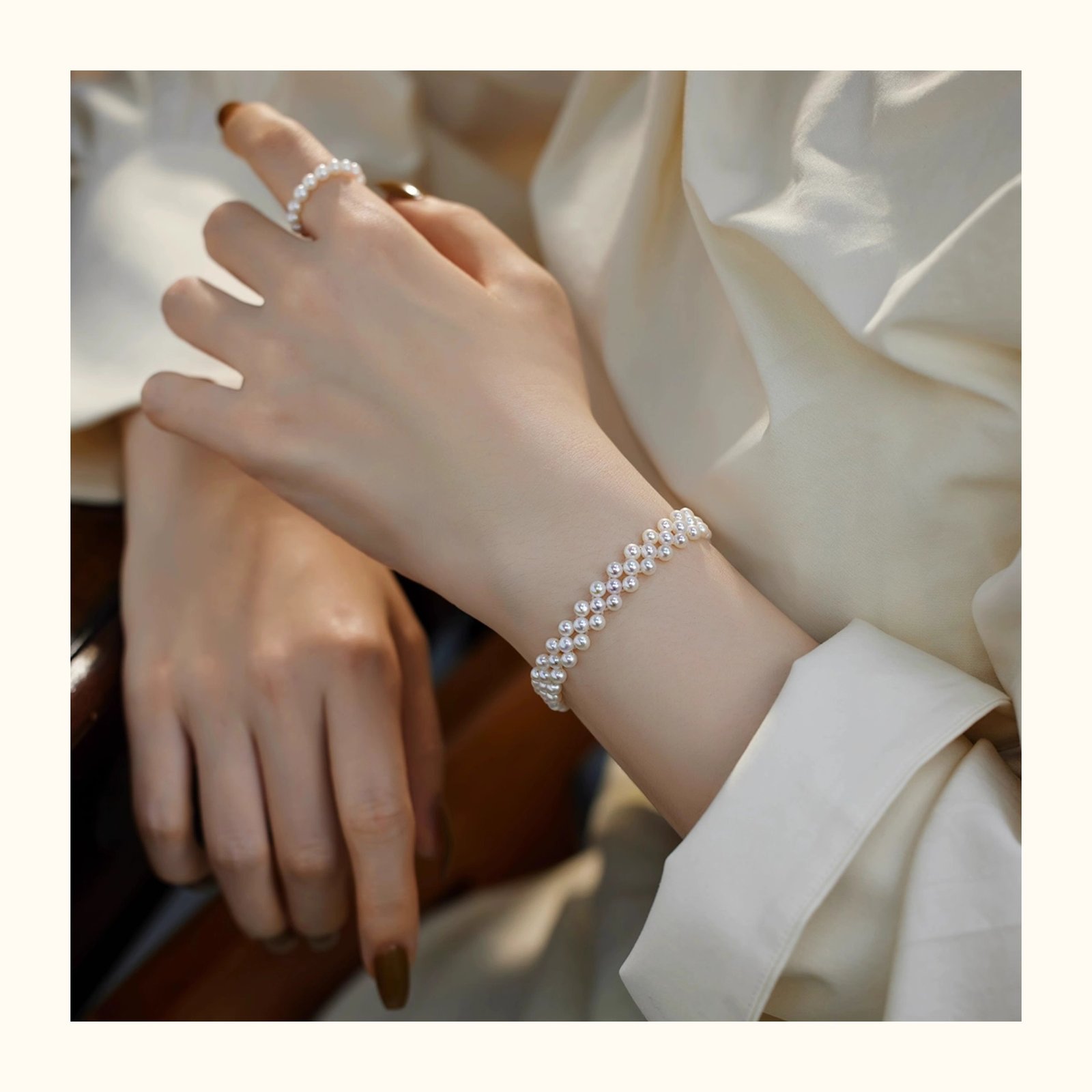Elegant woman wearing gold-tone hand-woven freshwater pearl bracelet on wrist, 3-4mm round pearls with S925 sterling silver, sophisticated everyday pearl jewelry.
